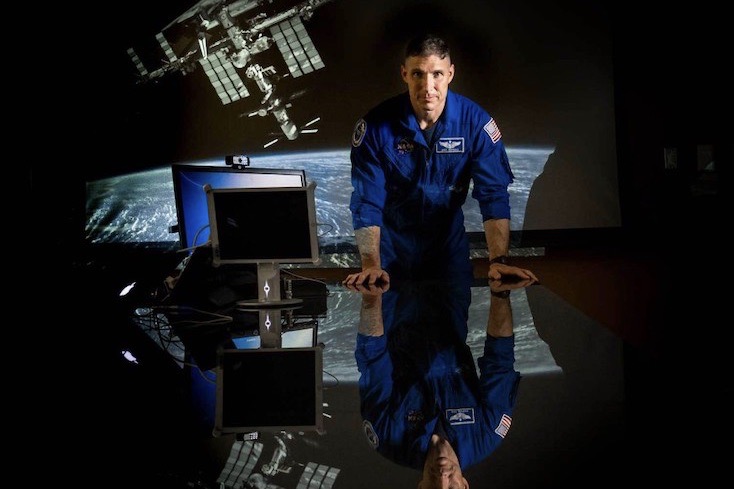 NASA Astronaut Col. Michael S. Hopkins leaning on a desk.